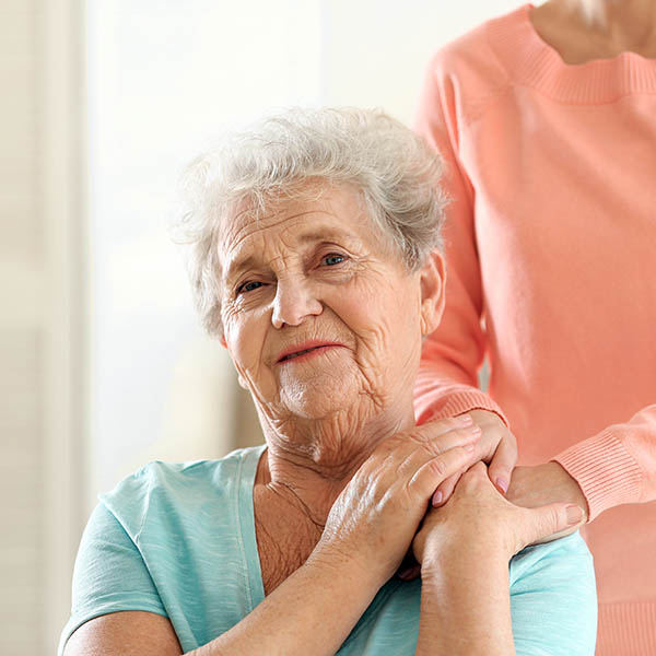 Health Care Planning in Vermont - image of elderly woman with family member's hands on her shoulder