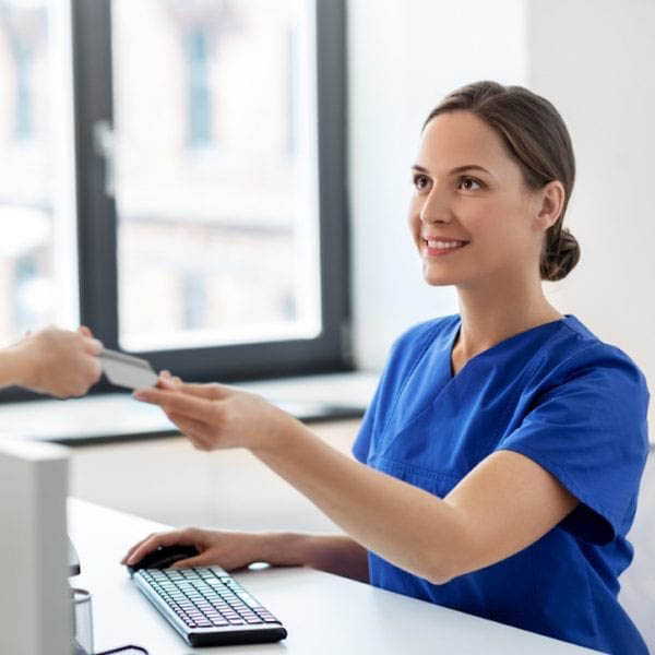 Image of nurse accepting a credit card
