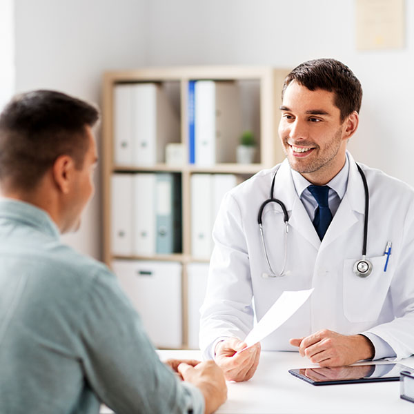 Health Care Referral in Vermont - doctor handing a referral slip to a patient