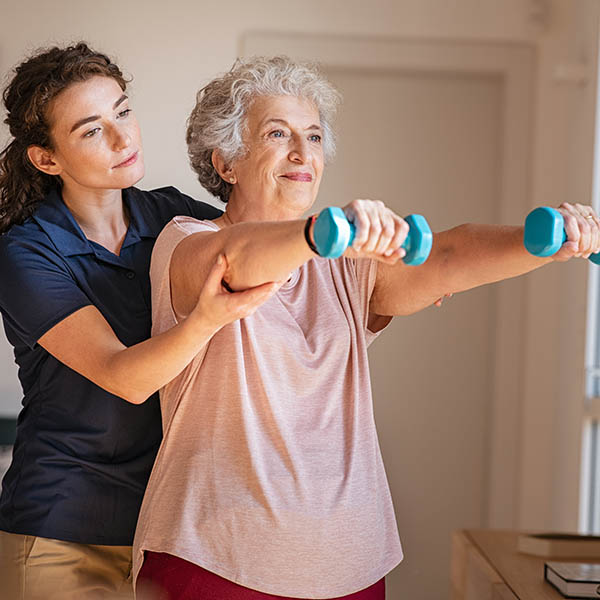 Rehabilitative Services in Vermont - image of nurse helping an elderly woman with weight training